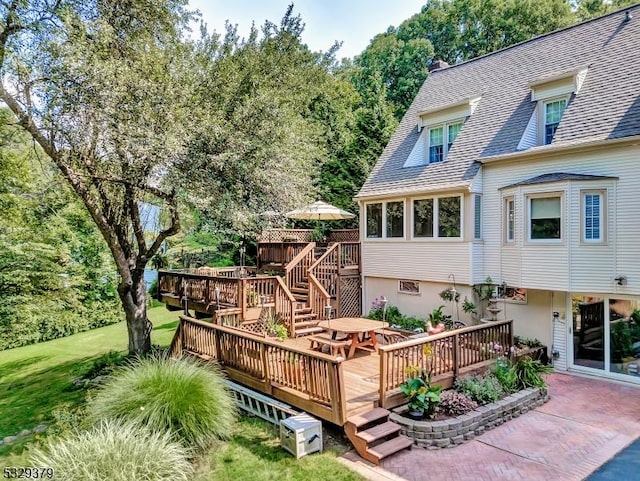 wooden deck with a lawn