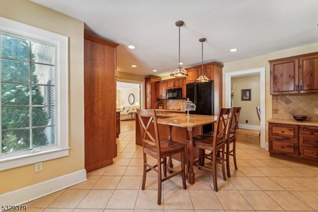 dining area with plenty of natural light and light tile patterned flooring