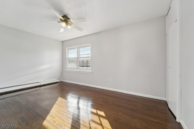 unfurnished bedroom featuring ceiling fan, dark hardwood / wood-style flooring, and a baseboard heating unit