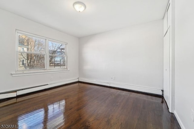 interior space featuring dark wood-type flooring and a baseboard radiator