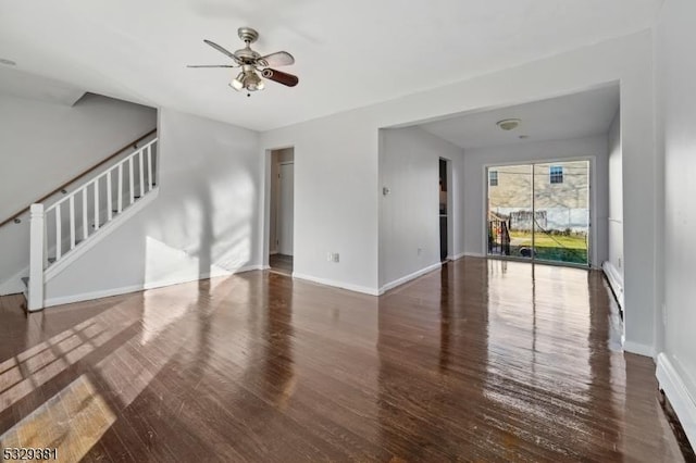 unfurnished living room featuring dark hardwood / wood-style flooring and ceiling fan