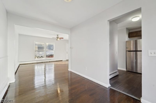 unfurnished room with dark hardwood / wood-style floors, ceiling fan, and a baseboard radiator