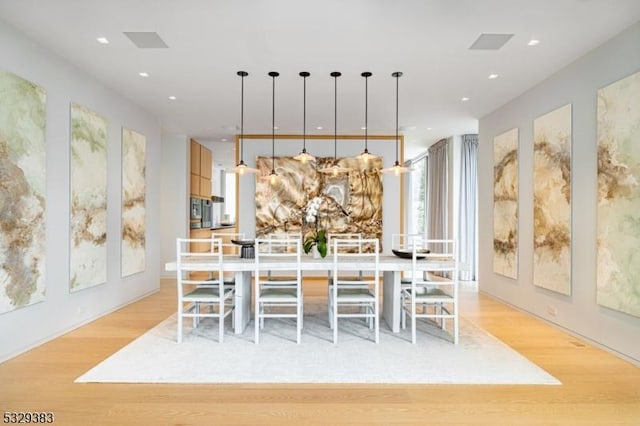 dining area with light hardwood / wood-style floors