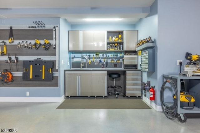 bar featuring sink and concrete floors