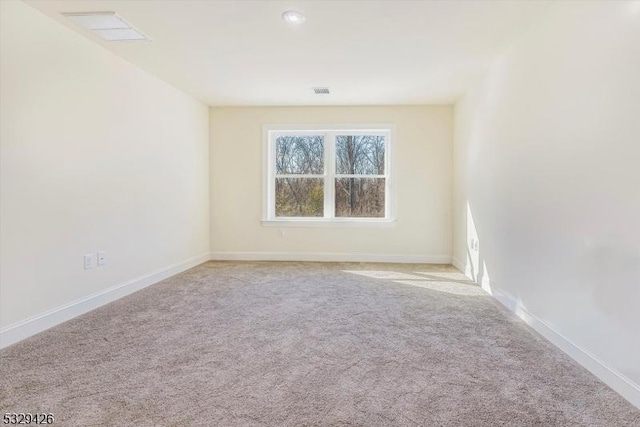 spare room with light colored carpet