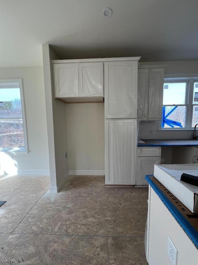 kitchen with a healthy amount of sunlight and white cabinets