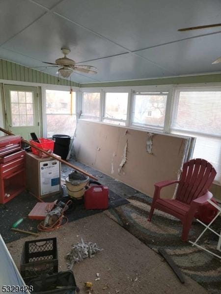 sunroom / solarium featuring a wealth of natural light and ceiling fan