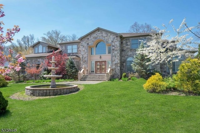 view of front of home with a front yard and french doors