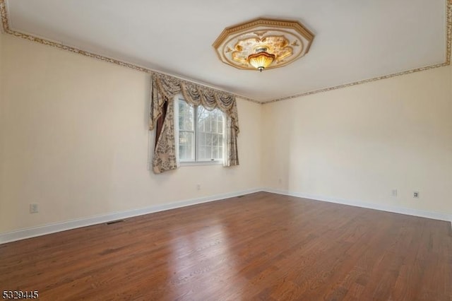 spare room with hardwood / wood-style flooring