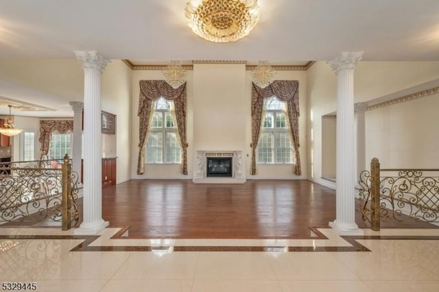 living room featuring hardwood / wood-style floors, a chandelier, and decorative columns