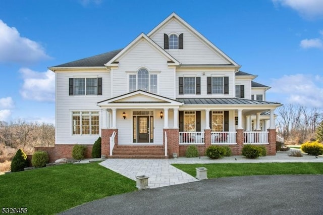 view of front of house with a front lawn and a porch