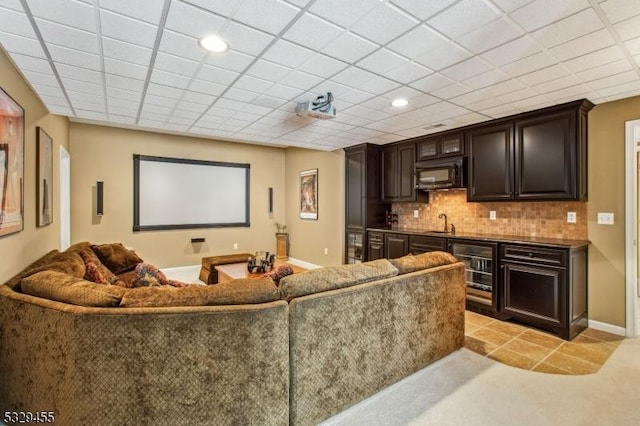 cinema with a paneled ceiling, wine cooler, and wet bar