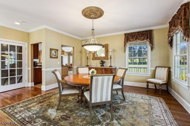 dining space with dark hardwood / wood-style flooring and ornamental molding