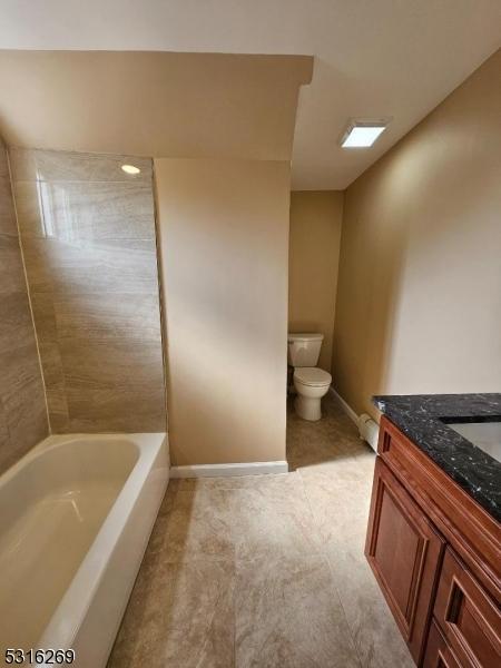 full bathroom with shower / bathing tub combination, vanity, and toilet