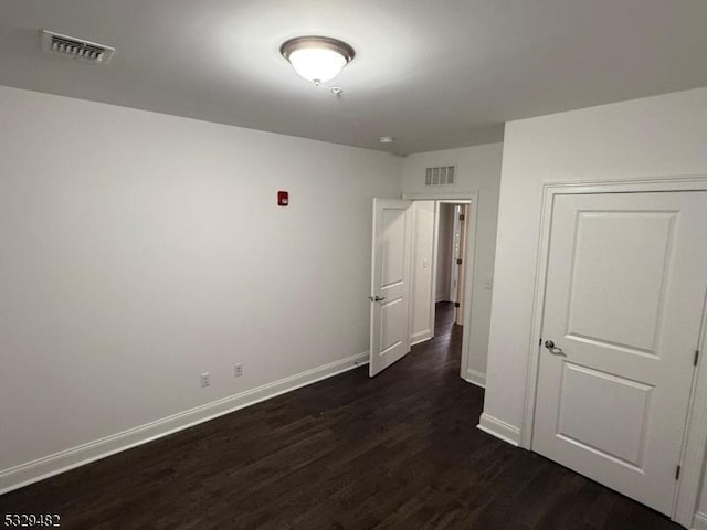 empty room featuring dark hardwood / wood-style floors