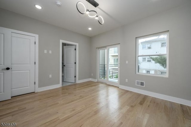 unfurnished bedroom featuring light hardwood / wood-style floors and access to outside