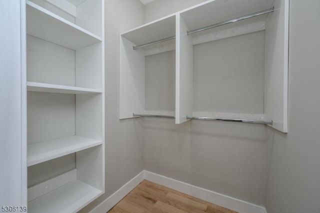 spacious closet featuring hardwood / wood-style floors