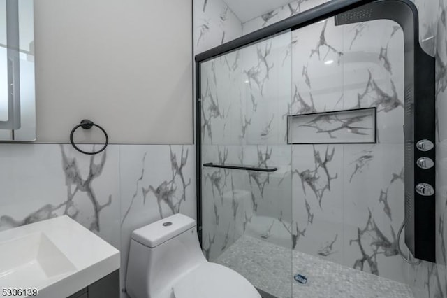 bathroom with walk in shower, vanity, toilet, and tile walls