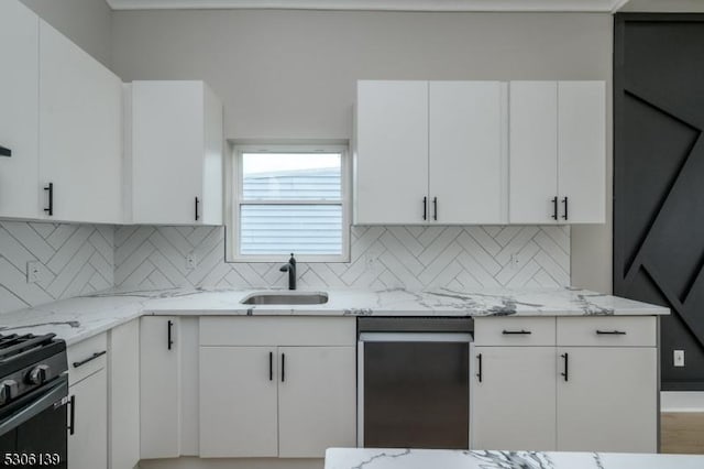 kitchen with backsplash, white cabinetry, sink, and light stone countertops