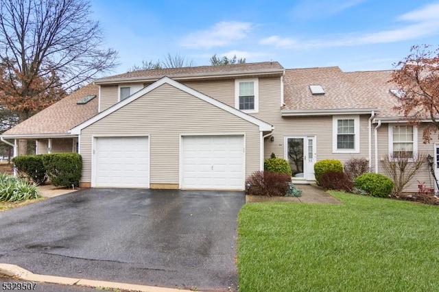 front of property with a front yard and a garage