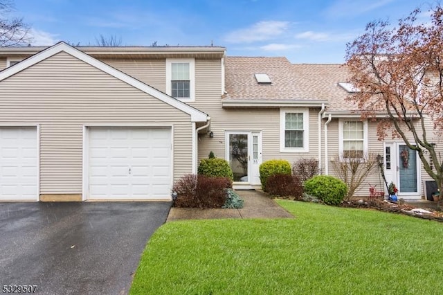 view of front of property with a garage and a front lawn