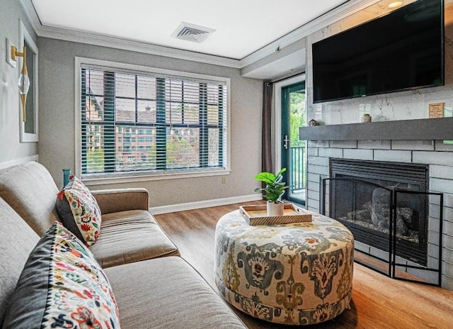 living room with hardwood / wood-style floors and crown molding