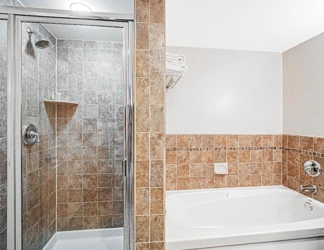 bathroom with separate shower and tub