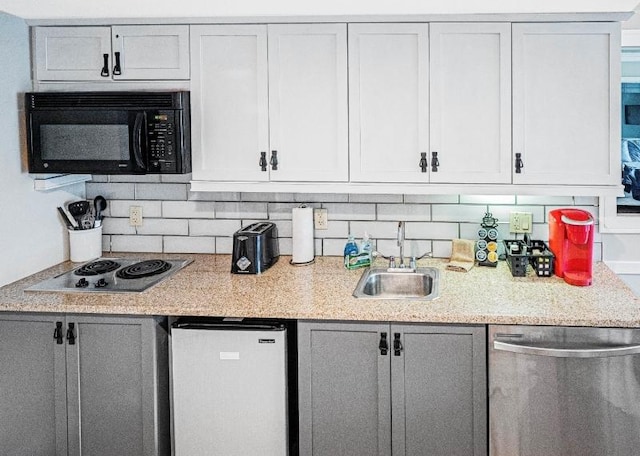 kitchen with backsplash, sink, and appliances with stainless steel finishes