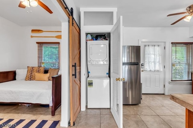 413B Lakeside Blvd, Hopatcong Boro, NJ 07843 - entryway featuring stacked washer / drying machine, a barn door, ceiling fan, and light tile patterned flooring