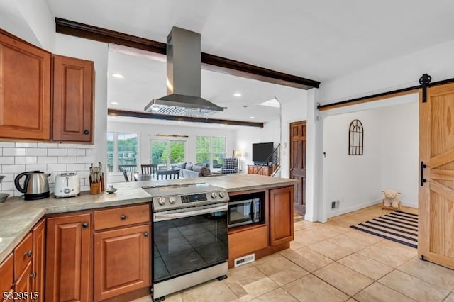 413B Lakeside Blvd, Hopatcong Boro, NJ 07843 - kitchen with stainless steel electric range, wall chimney range hood, a barn door, a peninsula, and light countertops