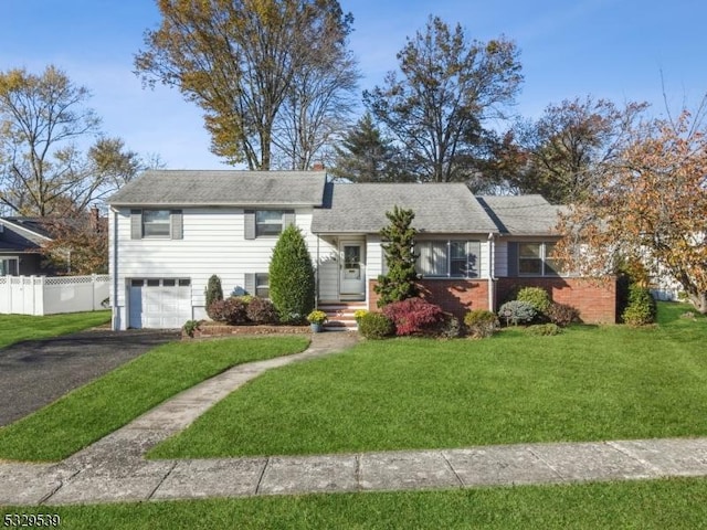 view of front facade with a garage and a front lawn