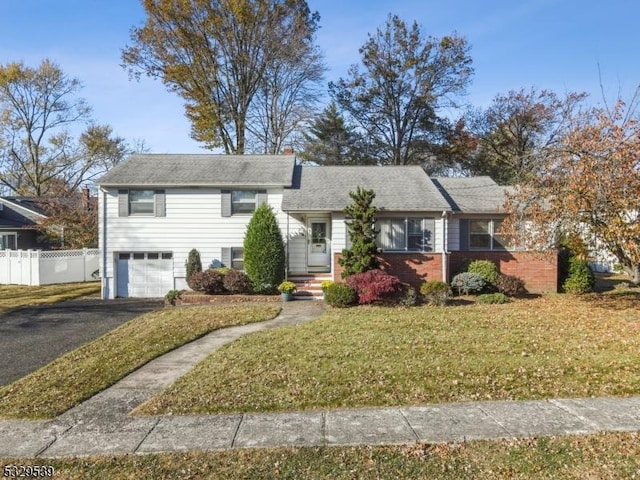 view of front of house with a garage and a front lawn