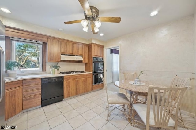 kitchen featuring light tile patterned floors, ceiling fan, and black appliances