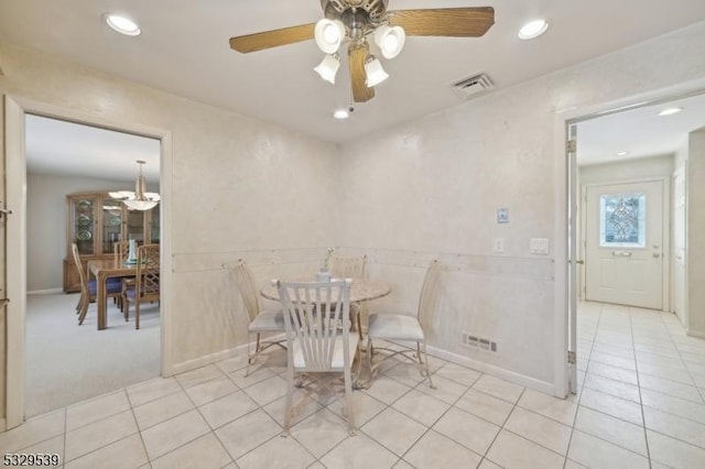 dining space with light tile patterned flooring and ceiling fan