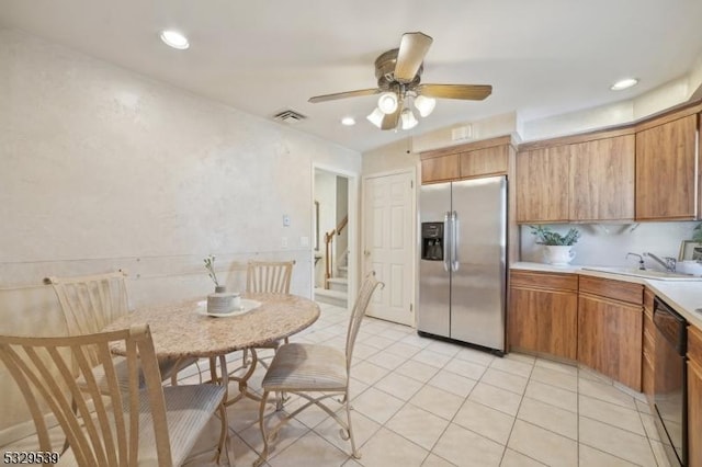 kitchen featuring stainless steel appliances, sink, light tile patterned floors, and ceiling fan