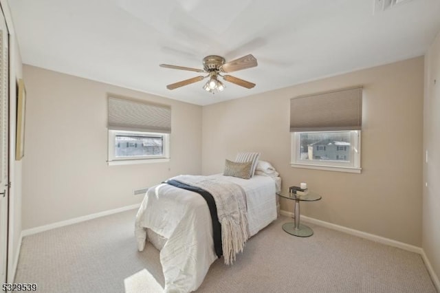 carpeted bedroom with ceiling fan