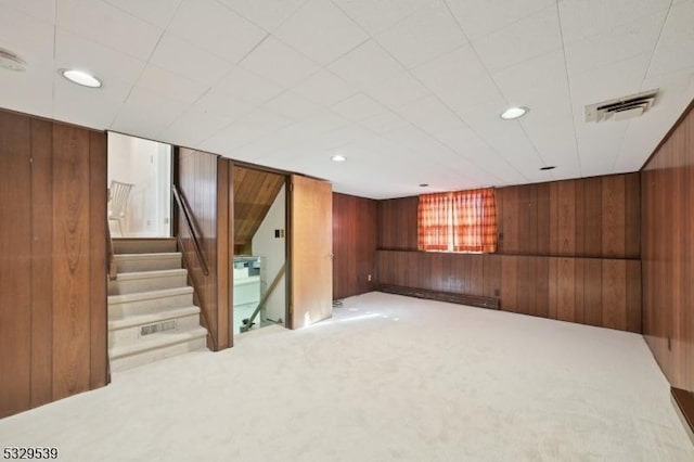 basement with wooden walls and carpet