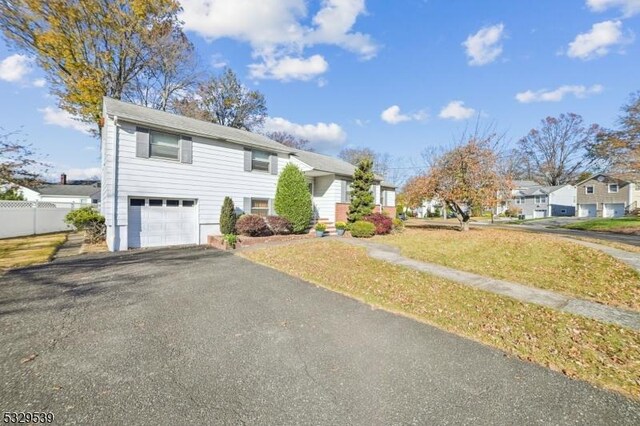 view of front of house with a garage and a front yard