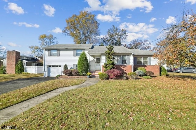 view of front of home featuring a garage and a front lawn