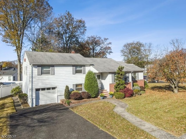 view of front of home featuring a garage and a front lawn