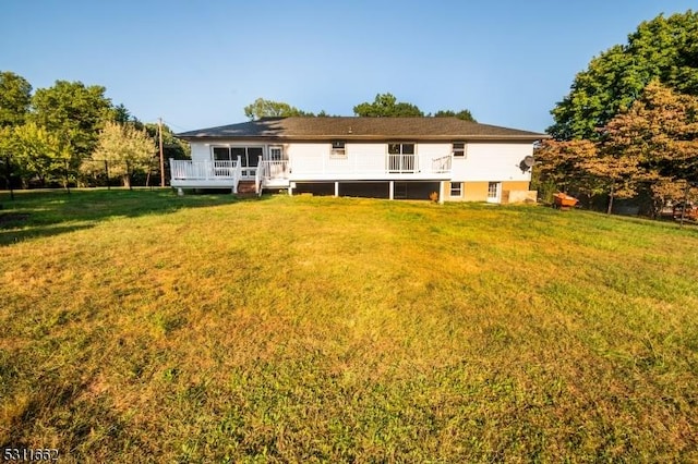 rear view of property with a yard