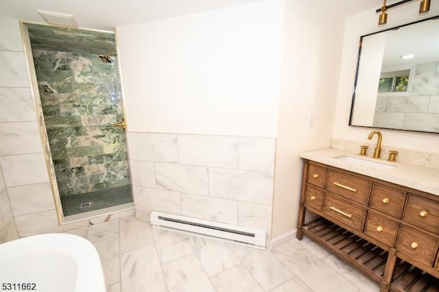 bathroom with plus walk in shower, vanity, baseboard heating, and tile walls