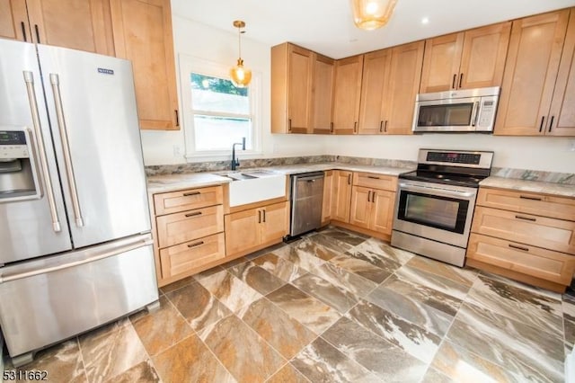 kitchen with pendant lighting, light brown cabinetry, sink, and appliances with stainless steel finishes