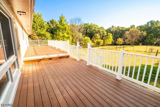 wooden deck featuring a lawn