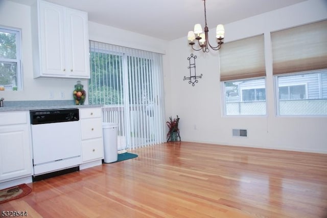 kitchen featuring visible vents, white cabinetry, light countertops, dishwasher, and a notable chandelier