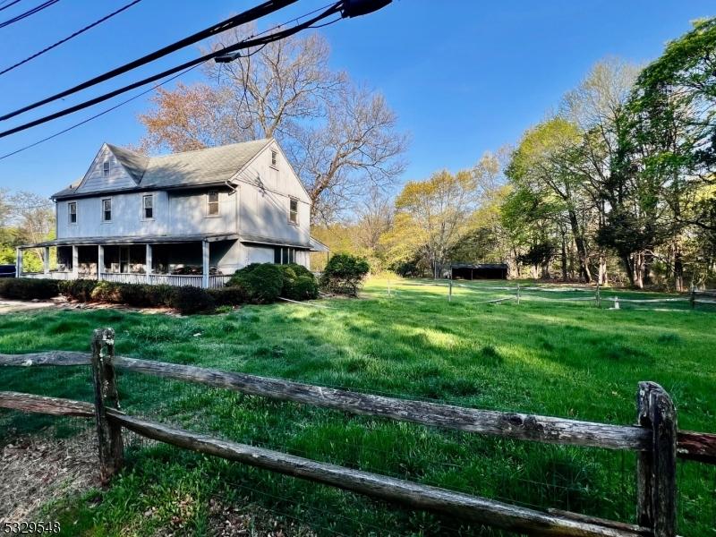 37 Dahmer Rd, Franklin Twp, NJ 08873 - view of side of home with a lawn and fence