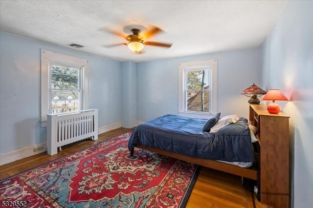 bedroom with hardwood / wood-style flooring and ceiling fan