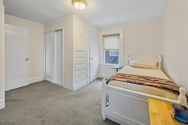 bedroom with light colored carpet and a closet