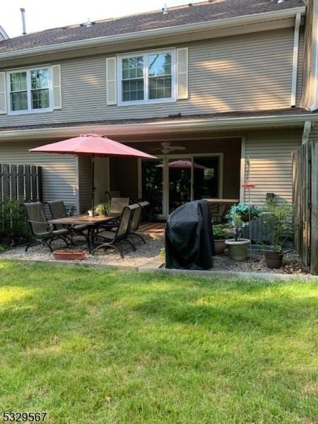 rear view of property with a patio area and a yard