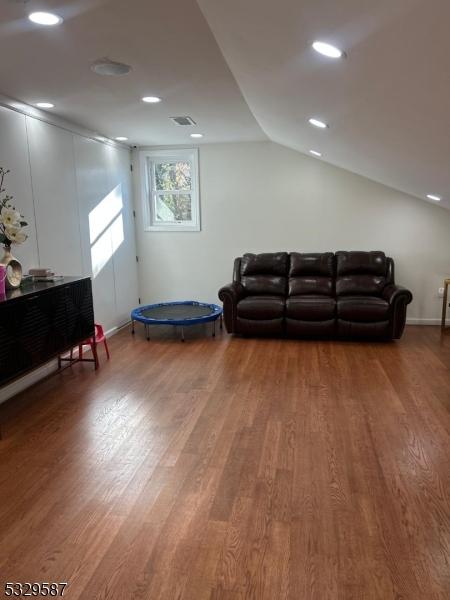 living room featuring hardwood / wood-style floors and lofted ceiling